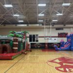 Kids lined up for a bounce house at a Conroe backyard party